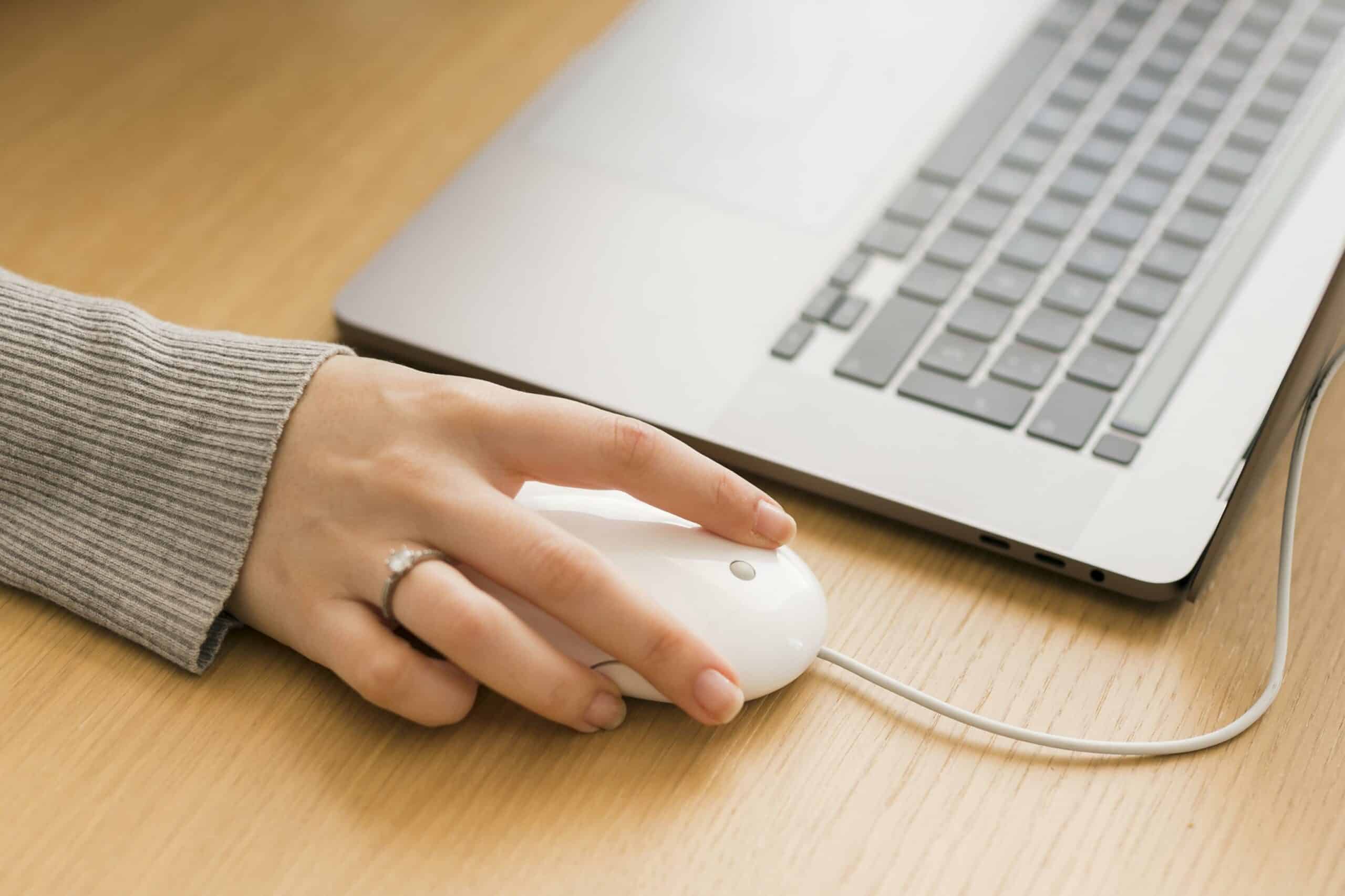 close up woman laptop using mouse
